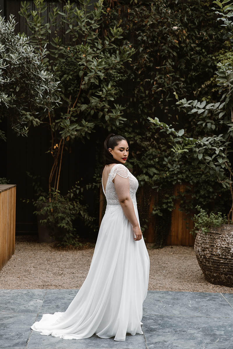 This soft flowing chiffon skirt is complimented by a beautiful beaded bodice and small cap sleeve, a prefect wedding dress for the elegant easy going bride