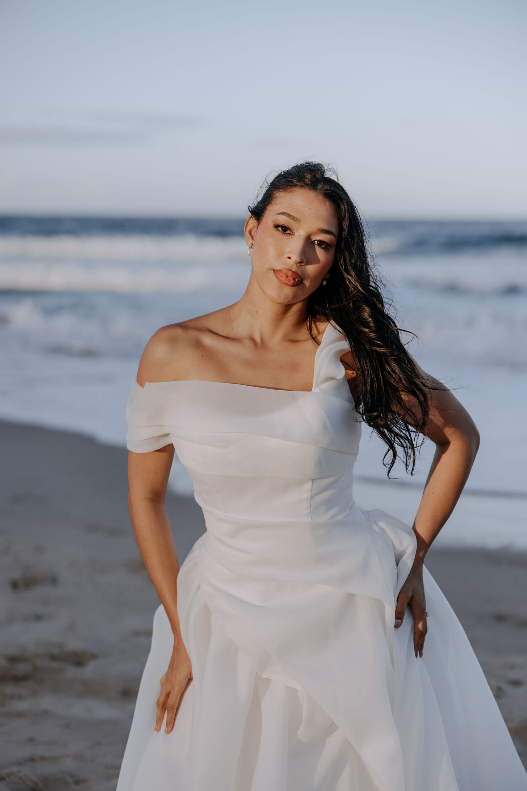 Regan is for the modern, fashion-forward bride. A deep neckline, A-line skirt & playful side-split adds the perfect juxtaposition of classic & edgy.